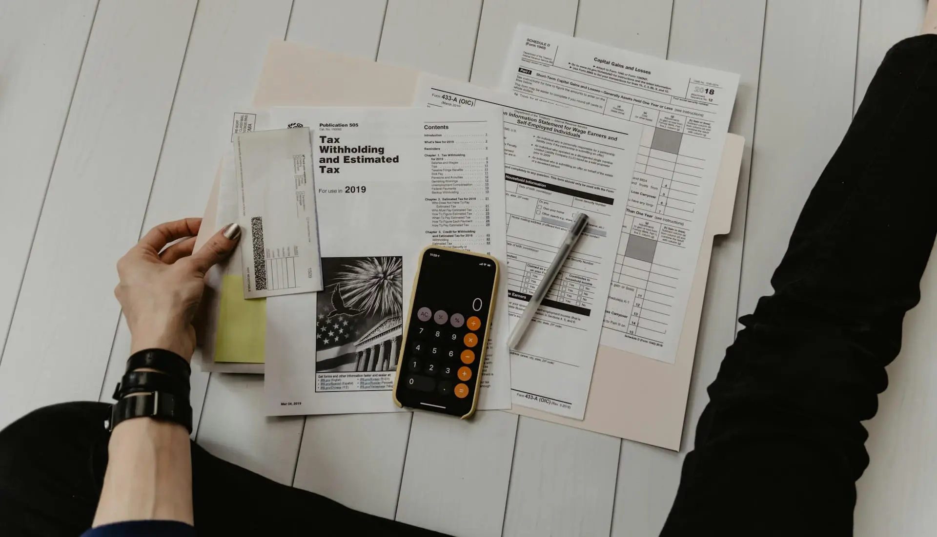 Tax documents and a calculator on a desk