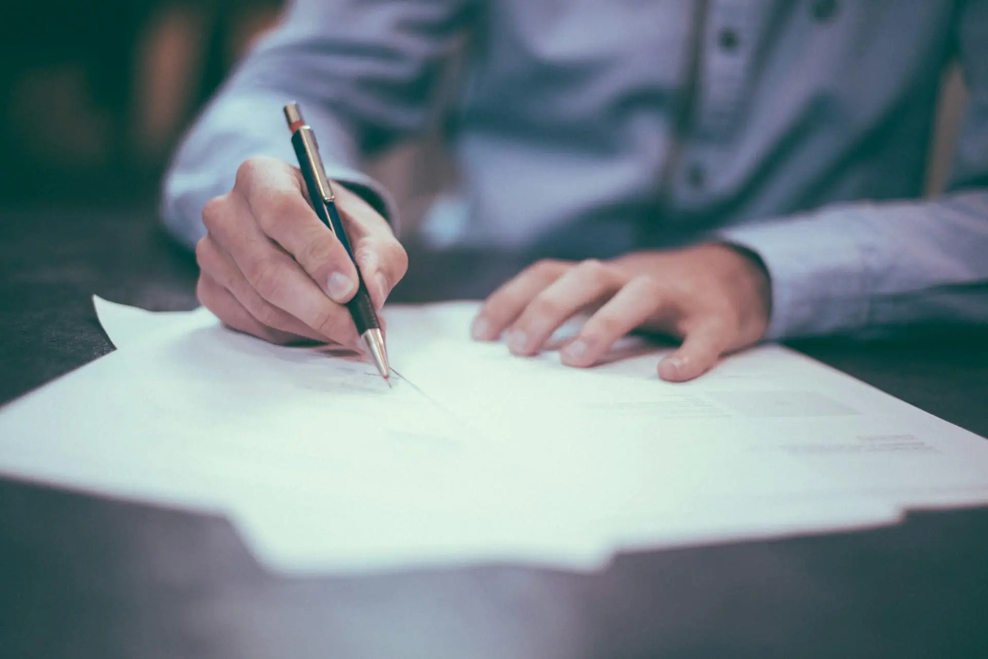 Business owner reviewing and signing accounting documents